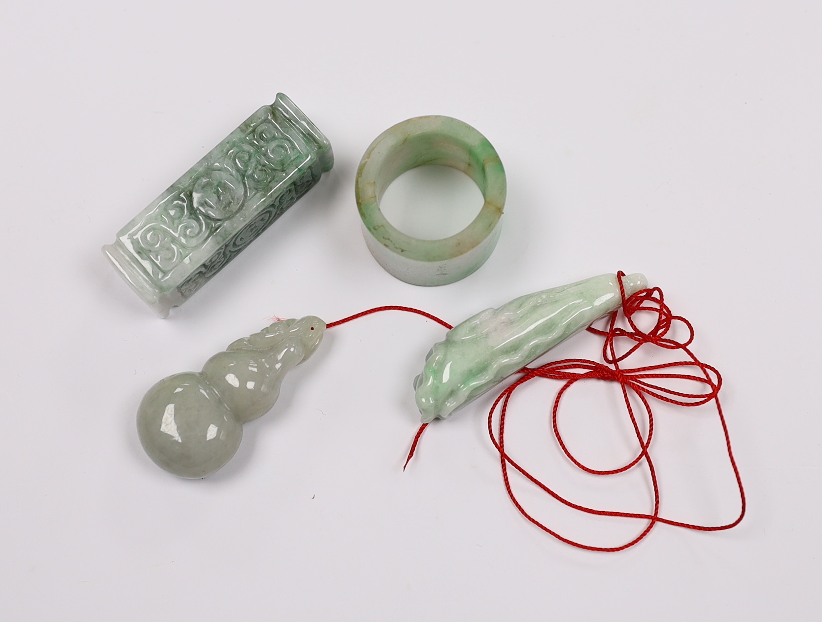 Four Chinese jadeite carvings including an archers ring